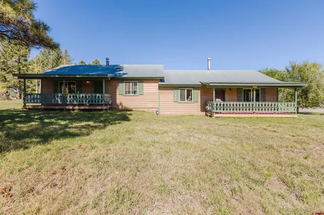 a view of a house with wooden fence