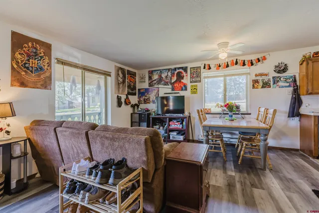 a room with furniture a flat screen tv and a floor to ceiling window