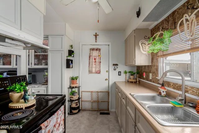 a kitchen filled a sink a counter space and a window