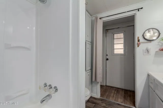 a bathroom with a sink a vanity and a window