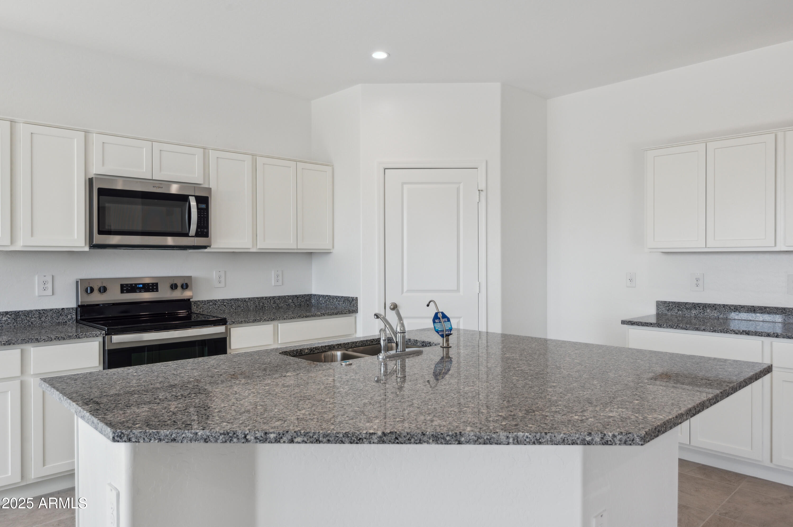 175 South Almoner Lane Casa Grande, AZ 85122 - Photo 27 of 54 a kitchen with granite countertop a sink a stove and microwave