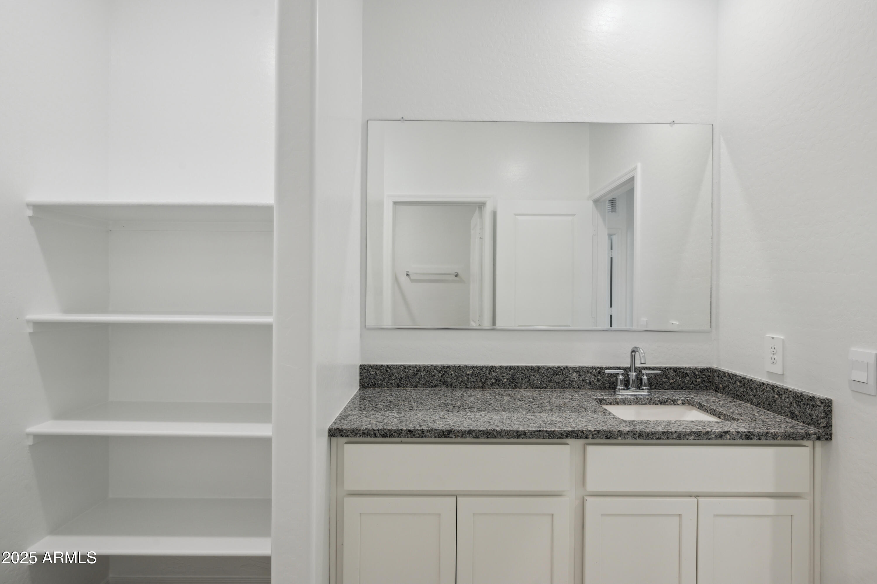 175 South Almoner Lane Casa Grande, AZ 85122 - Photo 40 of 54 a bathroom with a granite countertop sink and cabinets
