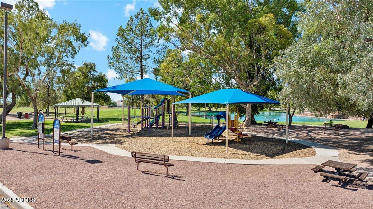 175 South Almoner Lane Casa Grande, AZ 85122 - Photo 9 of 54 a swimming pool with table and chairs under an umbrella
