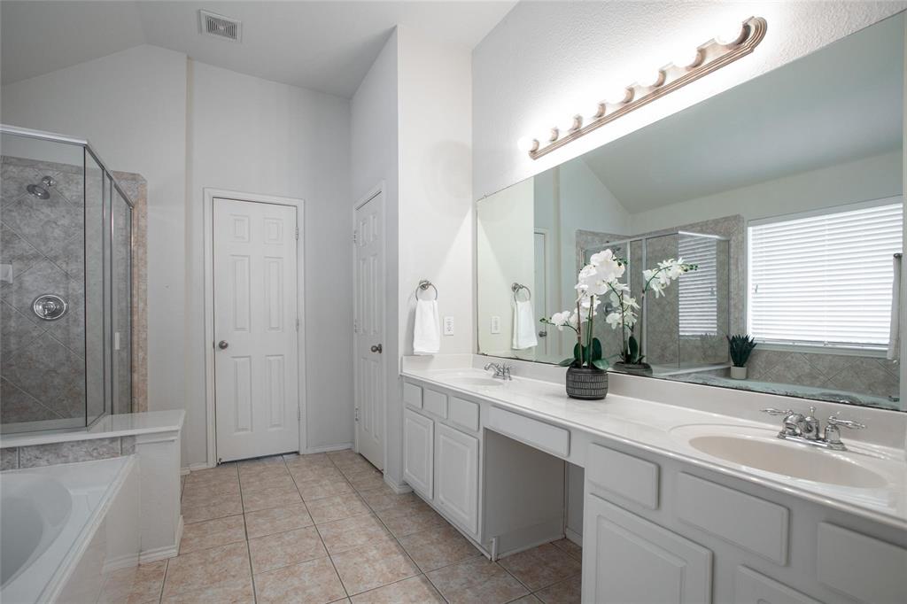 9305 Amber Downs Drive McKinney, TX 75072 - Photo 12 of 28 a bathroom with a sink and a mirror