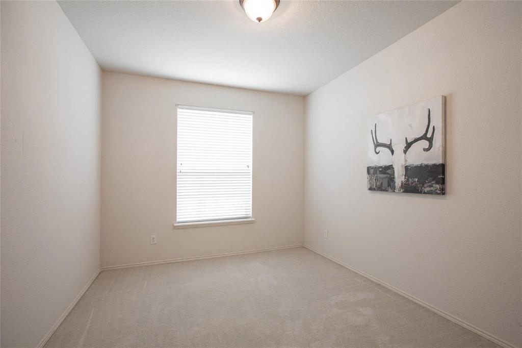 9305 Amber Downs Drive McKinney, TX 75072 - Photo 16 of 28 an empty room with a window and a ceiling fan