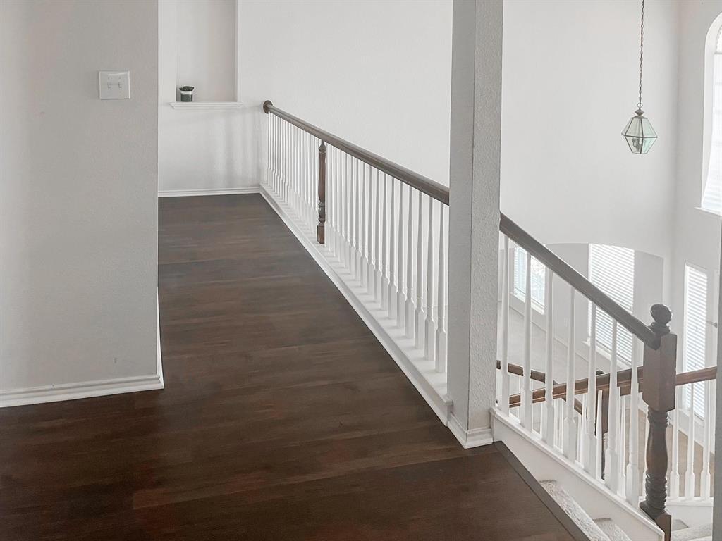 9305 Amber Downs Drive McKinney, TX 75072 - Photo 20 of 28 a view of staircase with railing and white walls
