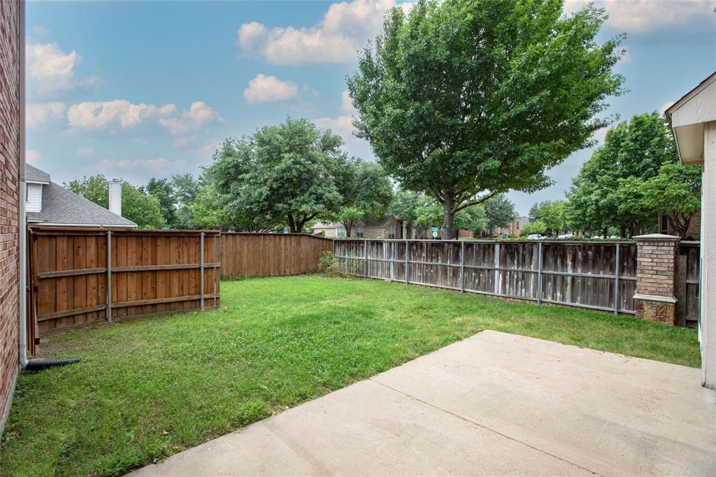 9305 Amber Downs Drive McKinney, TX 75072 - Photo 24 of 28 a view of a backyard with a garden and wooden fence