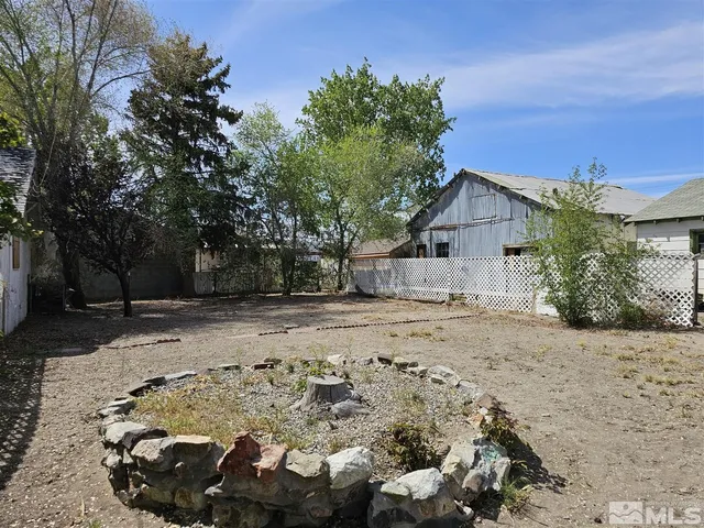 a view of a backyard with large trees