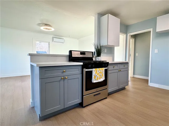 a kitchen with granite countertop a stove a sink and a microwave