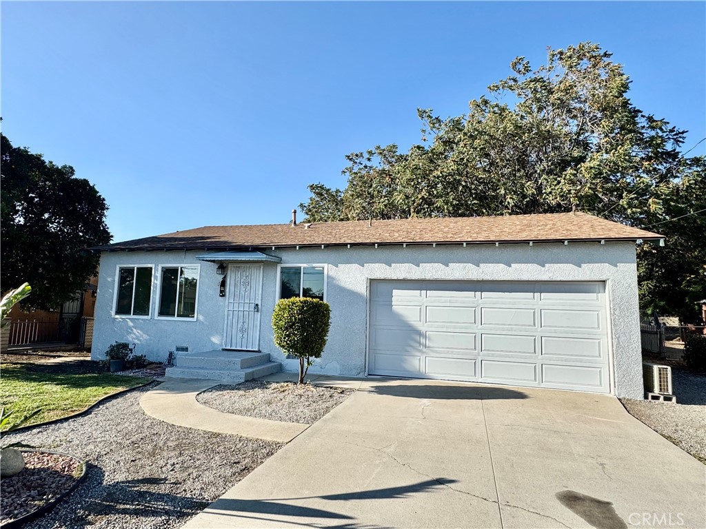 3944 East 9th Street Pomona, CA 91766 - Photo 21 of 22 a front view of a house with a yard and garage