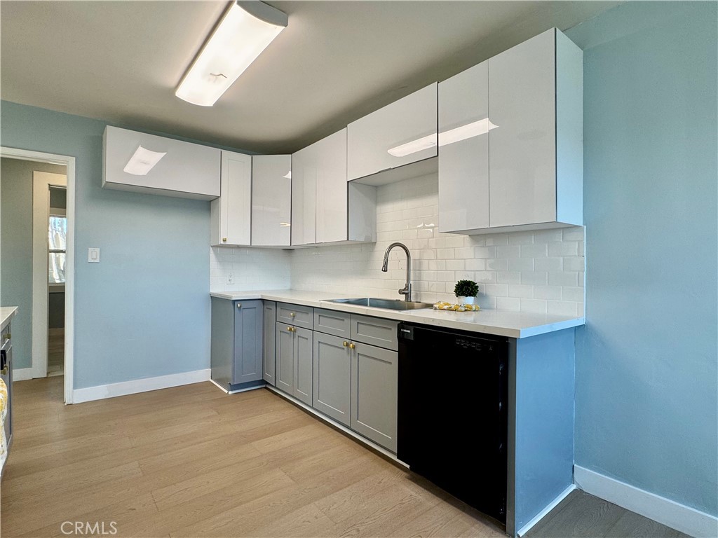 3944 East 9th Street Pomona, CA 91766 - Photo 4 of 22 a kitchen with stainless steel appliances granite countertop a sink and cabinets