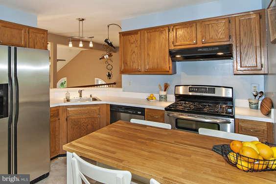 2803 Deer Ridge Drive Silver Spring, MD 20904 - Photo 12 of 30 a kitchen with stainless steel appliances granite countertop a sink stove and refrigerator