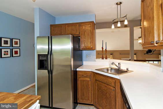 2803 Deer Ridge Drive Silver Spring, MD 20904 - Photo 13 of 30 a kitchen with stainless steel appliances granite countertop a sink a refrigerator and a stove