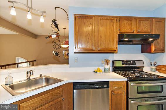 2803 Deer Ridge Drive Silver Spring, MD 20904 - Photo 14 of 30 a kitchen with a sink a stove and cabinets