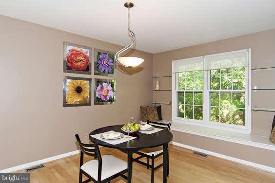 2803 Deer Ridge Drive Silver Spring, MD 20904 - Photo 10 of 30 a view of a dining room with furniture wooden floor and a chandelier