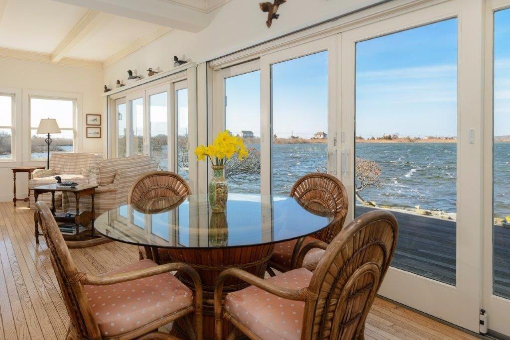 a dining room with furniture a chandelier and wooden floor