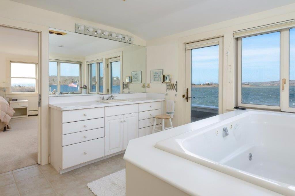 333 Mill Road Falmouth, MA 02540 - Photo 17 of 28 a spacious bathroom with a tub sink and mirror