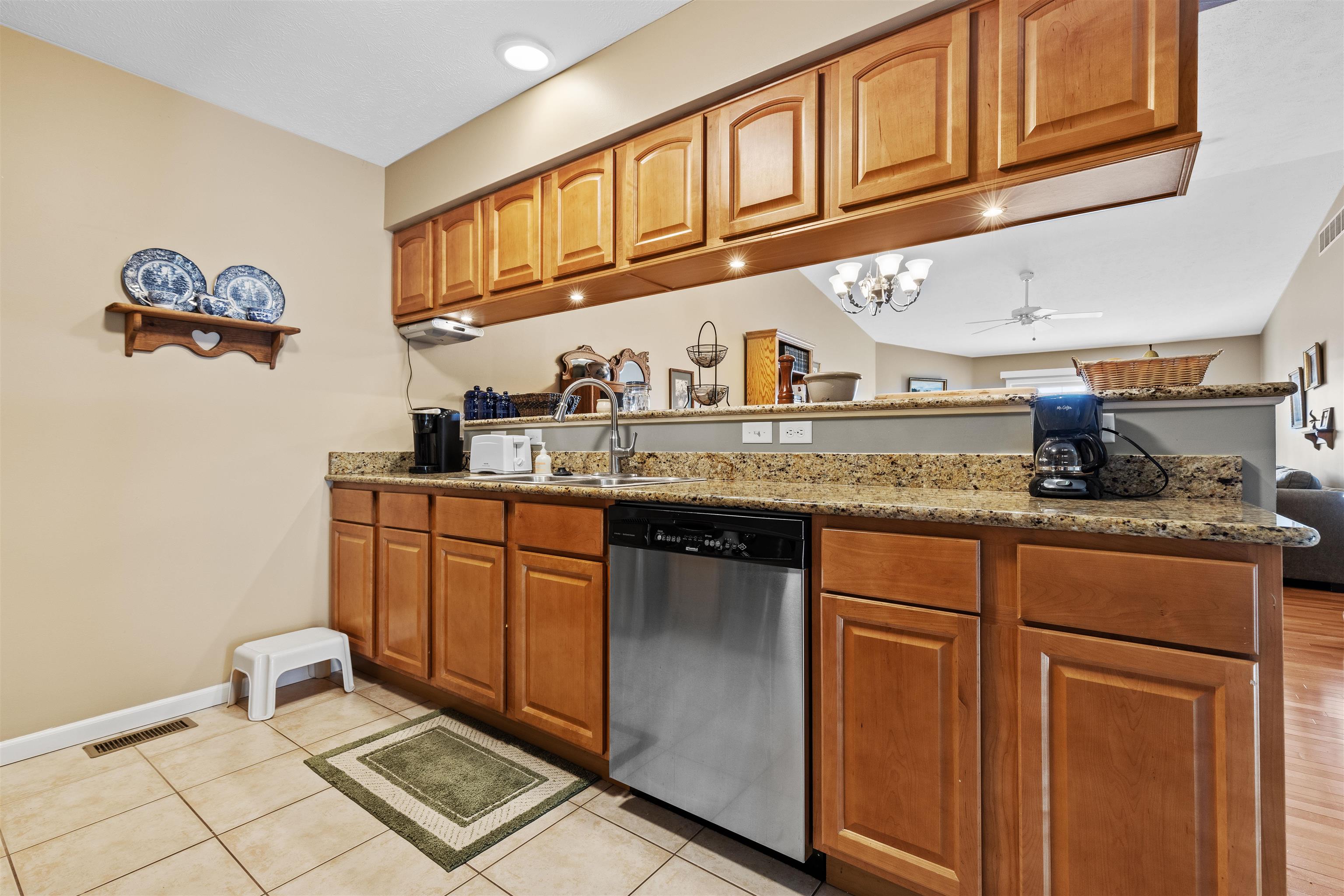 4841 Snowcap Run Loves Park, IL 61111 - Photo 6 of 18 a kitchen with stainless steel appliances granite countertop a sink and cabinets
