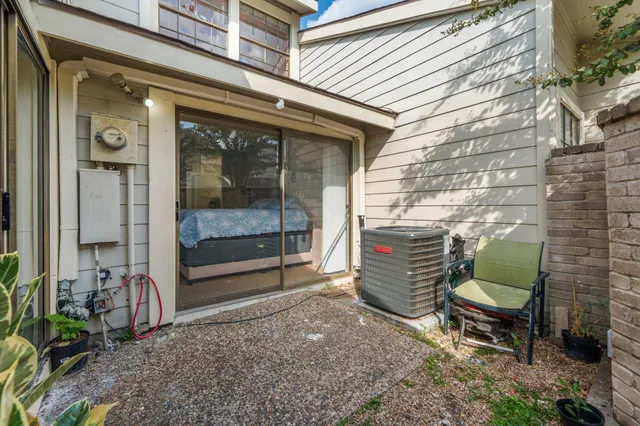 a backyard of a house with outdoor seating and barbeque oven