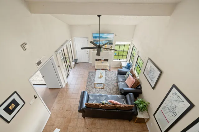 a living room with furniture and a chandelier