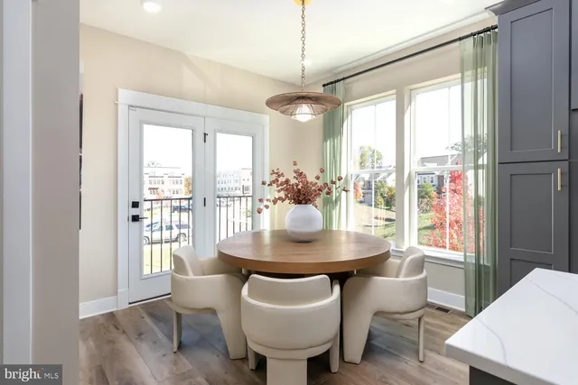 a dining room with furniture window and wooden floor