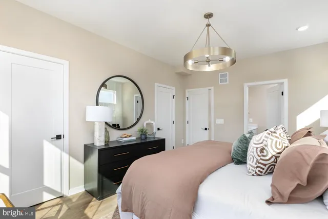 a bedroom with bed and a chandelier