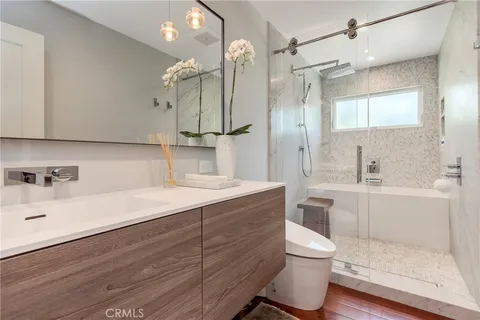 a bathroom with a sink a toilet and shower