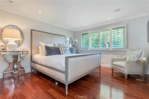 a bedroom with a bed a table and chair