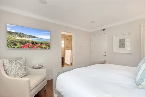 a bedroom with a bed and wall painting