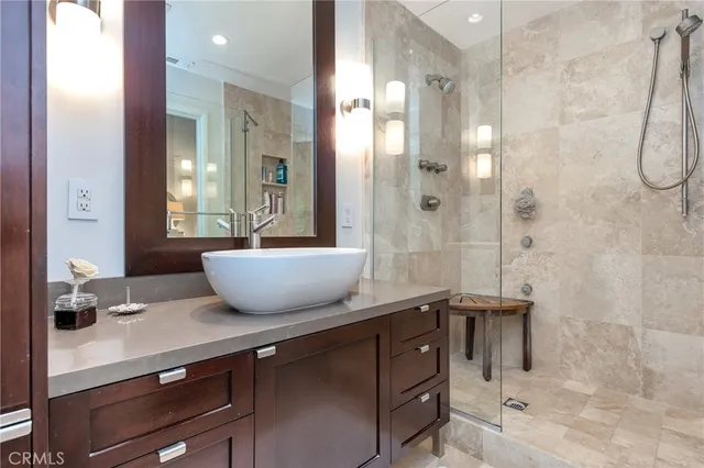 a bathroom with a double vanity sink a mirror and a shower