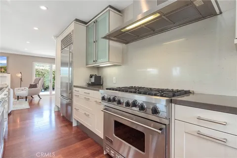 a kitchen with a stove and white cabinets