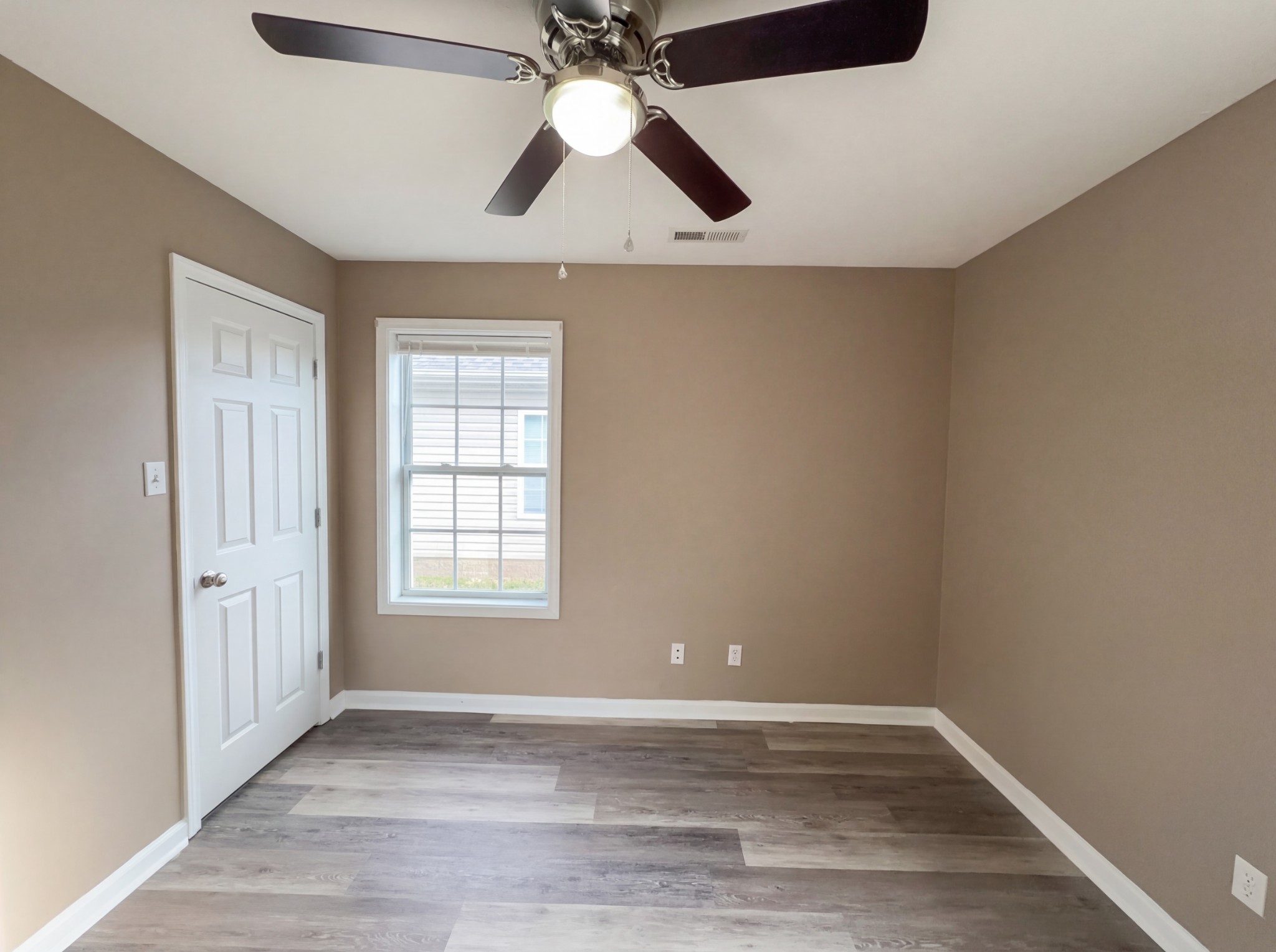 511 Bridle Way Hopkinsville, KY 42240 - Photo 9 of 17 an empty room with wooden floor fan and windows