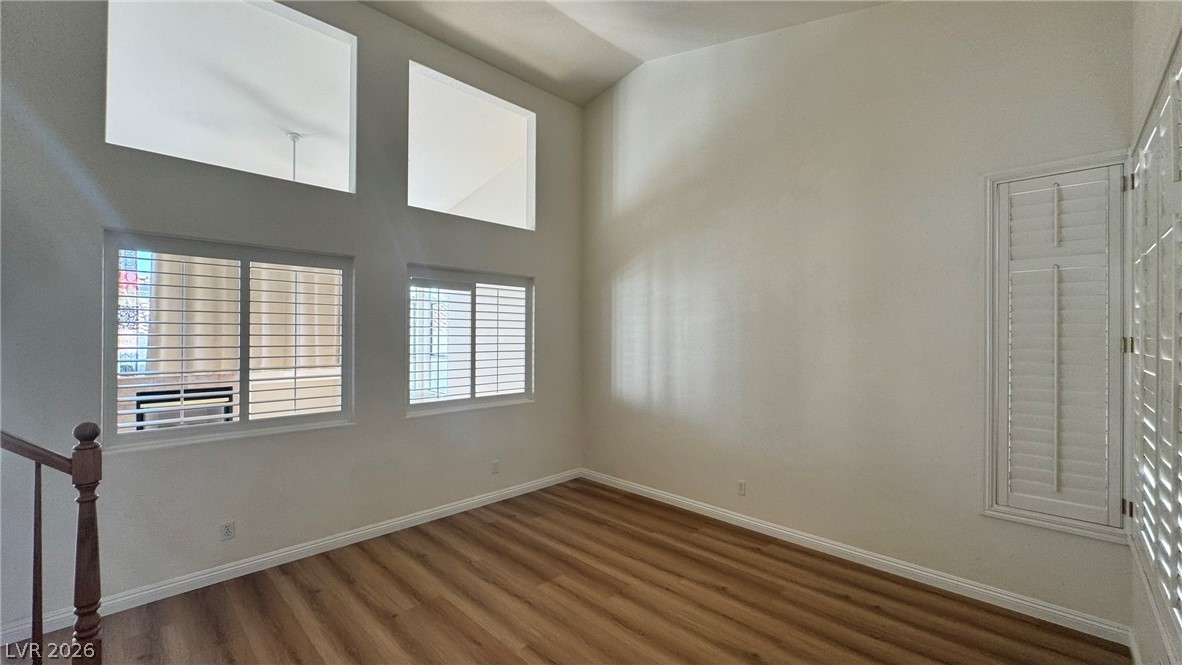 9716 Ridge Creek Place Las Vegas, NV 89134 - Photo 5 of 28 This airy room features natural light and rich wood flooring, ideal for versatile living.
