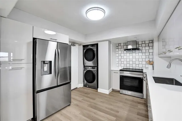 a kitchen with a refrigerator and a sink