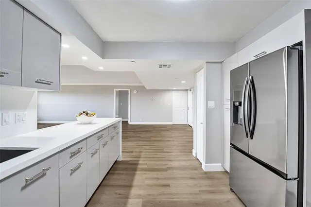 a view of empty room with wooden floor and window