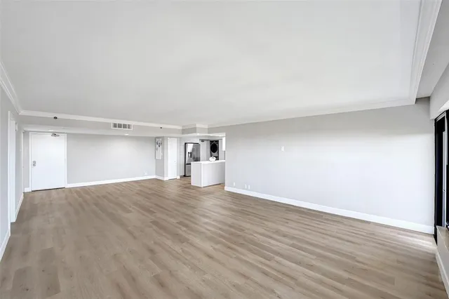 a view of kitchen with stainless steel appliances a refrigerator and cabinets