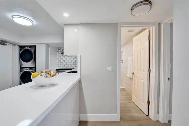 a view of an empty room and window with wooden floor
