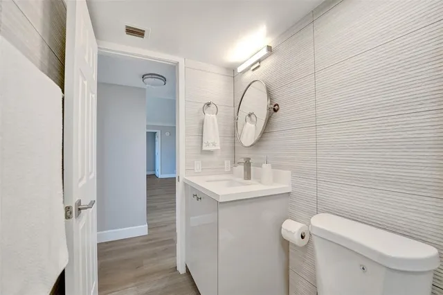 a bathroom with a double vanity sink mirror and bathtub