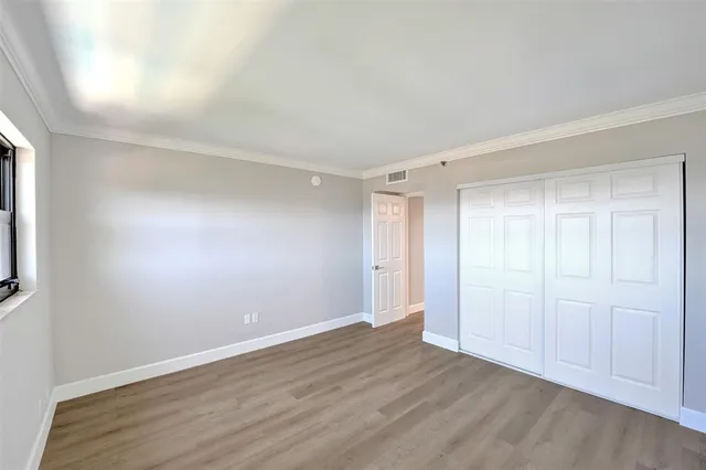 a white toilet sitting next to a white tub