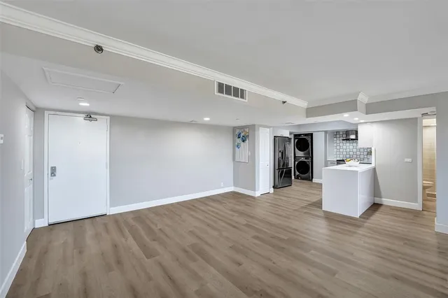 a large kitchen with stainless steel appliances kitchen island a large counter space a sink and a refrigerator