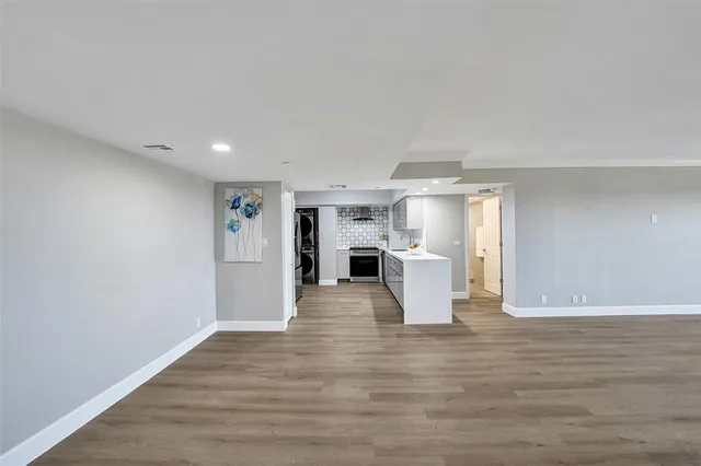 a kitchen with stainless steel appliances granite countertop a refrigerator a stove and a sink