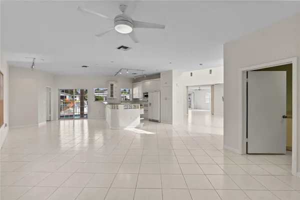 a view of an empty room with a fireplace and a window