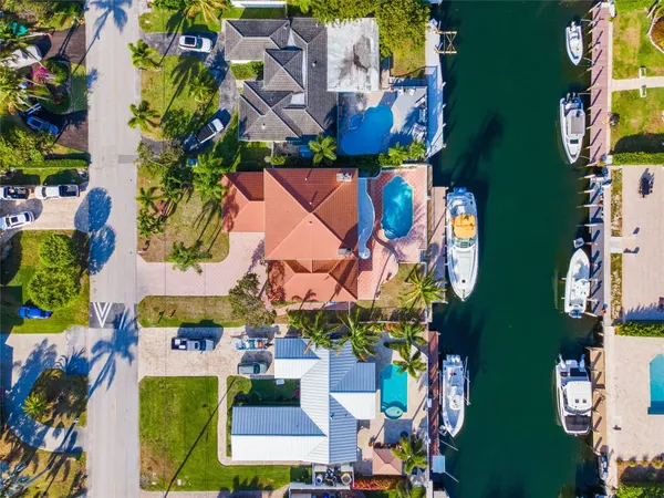 an aerial view of a house with swimming pool lake view and mountain view