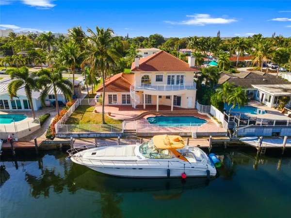 an aerial view of a swimming pool with outdoor seating