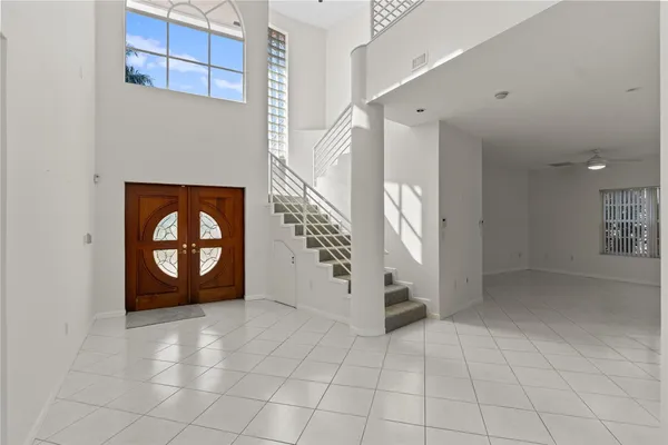 a view of an empty room with a fireplace and a window