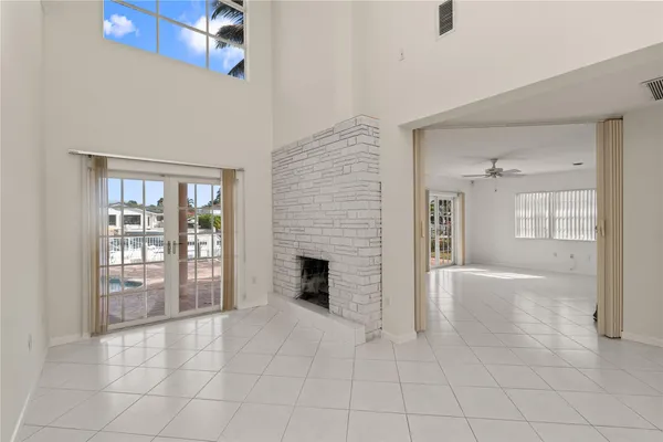 a view of an empty room with window and cabinet