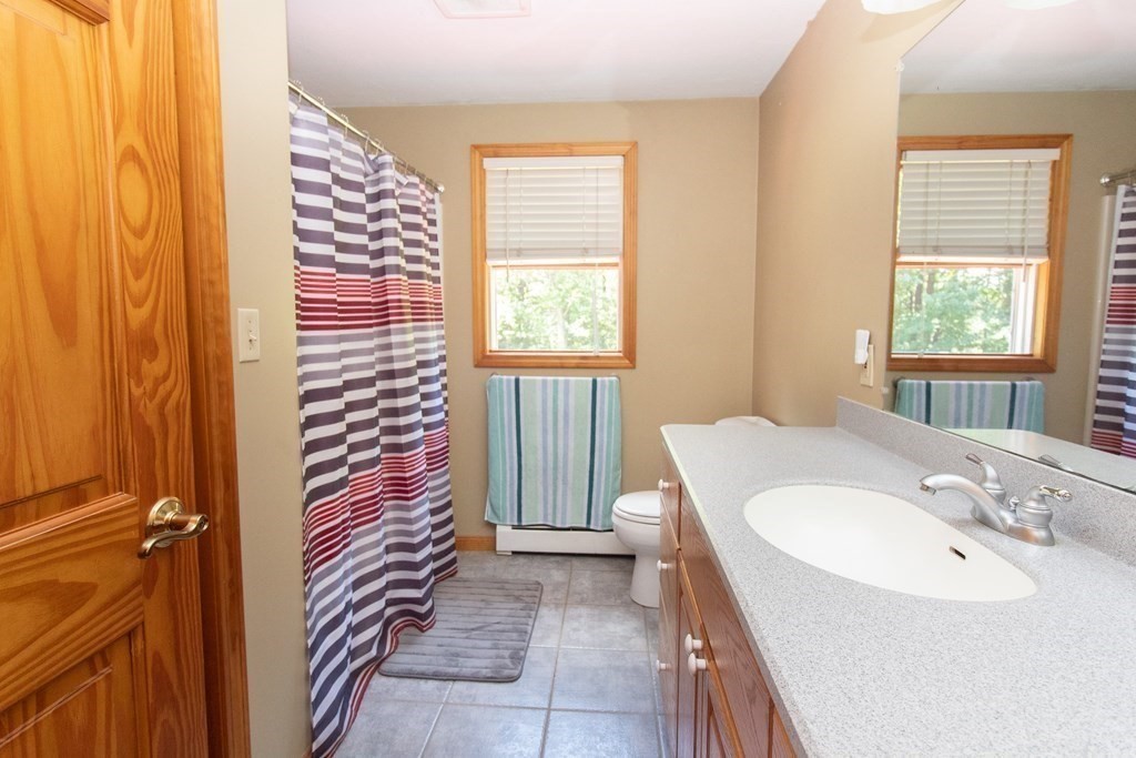 72 Bond Road Charlton, MA 01507 - Photo 12 of 36 a bathroom with a sink a mirror and a shower