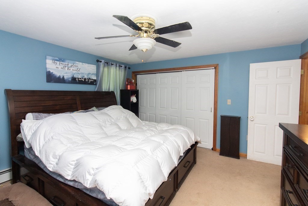 72 Bond Road Charlton, MA 01507 - Photo 19 of 36 a bedroom with a large bed and a ceiling fan