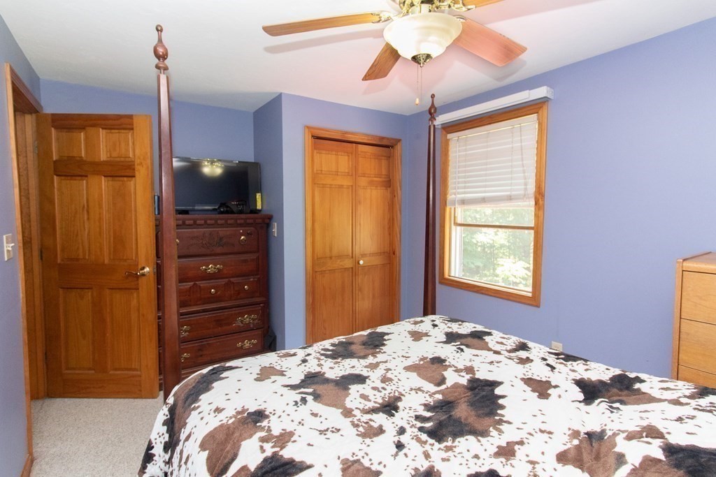 72 Bond Road Charlton, MA 01507 - Photo 20 of 36 a bedroom with a bed and a flat tv screen on dresser