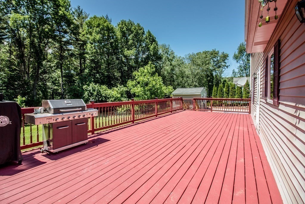 72 Bond Road Charlton, MA 01507 - Photo 25 of 36 a view of a wooden deck with a yard